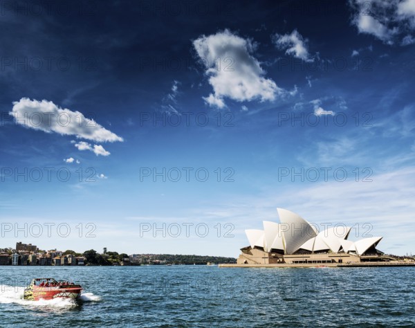 Famous sydney landmark opera house view with speed boat in australia on sunny day