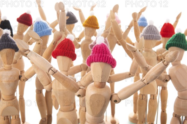 Many wooden mannequins with winter hat isolated over white