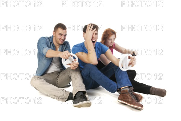 Three young friends ar gaming with the computer