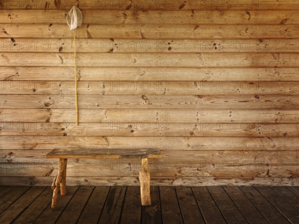 Butterfly net and bench against wooden wall