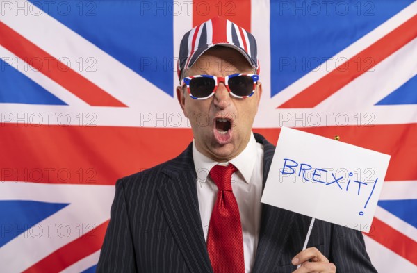 British male businessman with Brexit banner and UK flag