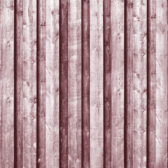 Close-up view of weathered wooden planks creating a rustic red background.Belarus