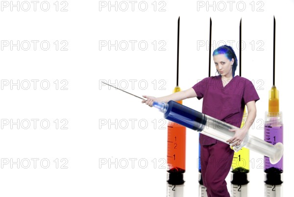 A medical doctor or nurse in scrubs preparing an injection in a giant syringe