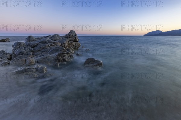 Rocks in the sea on the beach of Torre di Bari at sunset, long exposure, Torre di Bari, Bari Sardo, Ogliastra, Sardinia, Italy, Europe