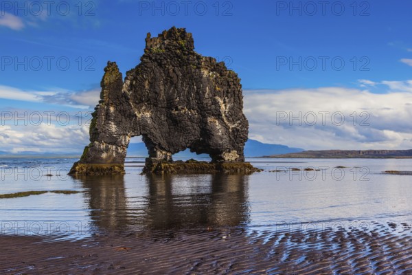 The picturesque cliff in Iceland as huge prehistoric monster. Remains of an ancient extinct volcano Hvitserkur on the sea shelf