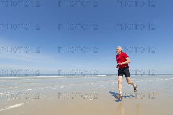 Elder man running at the beach