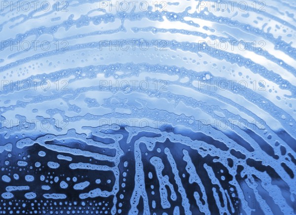 Soap foam bubbles on the glass