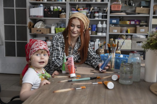 A delightful art session where a mother and child engage in creative activities, showcasing bonding and joy
