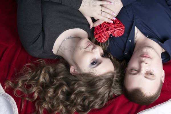 Couple in love from top to bottom. Man and woman with a red heart. Beautiful young man and woman.close up man and woman together.valentine's day