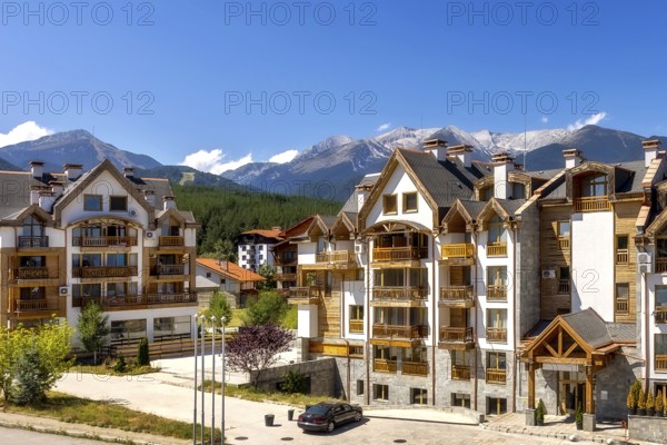 Bansko, Bulgaria summer view with houses and Pirin peaks panorama