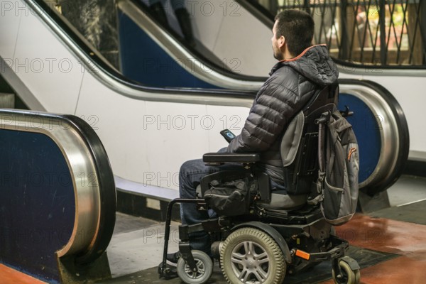 Rear View Of A Disabled Man On Wheelchair In Front Of Staircase