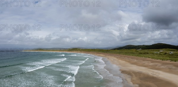 A panorama aerial view of the golden sand beach and turquoise waters of the beach at Narin-Portnoo