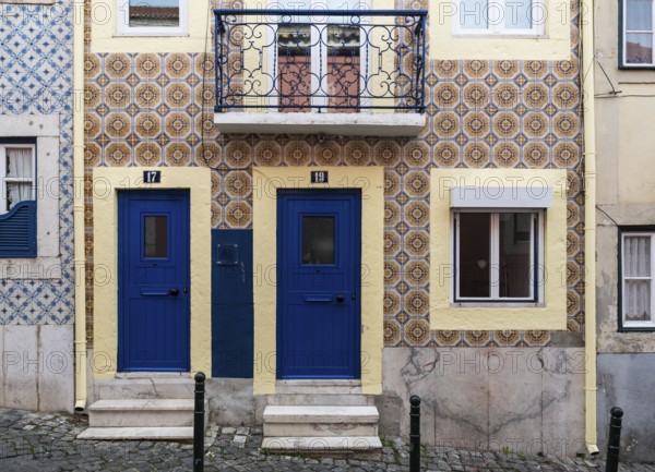 Lisbon, Portugal, 12 28 2018: Typical Portuguese facade with tiles and two small blue doors, Europe