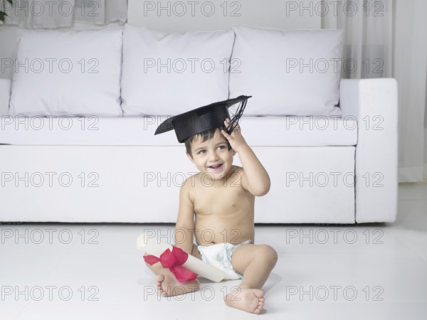 Baby holding degree certificate, MR#779O