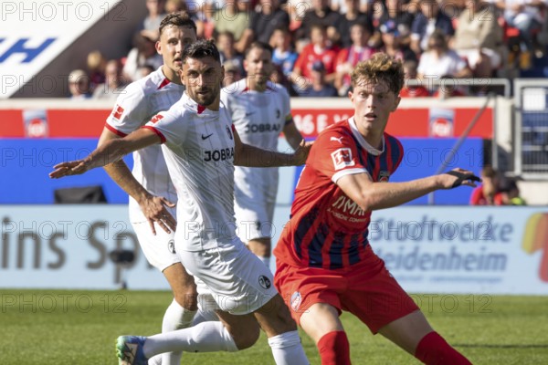Football match, Vincenzo GRIFO SC Freiburg left and Paul WANNER 1. FC Heidenheim waiting for a cross and looking to the left, Voith-Arena football stadium, Heidenheim