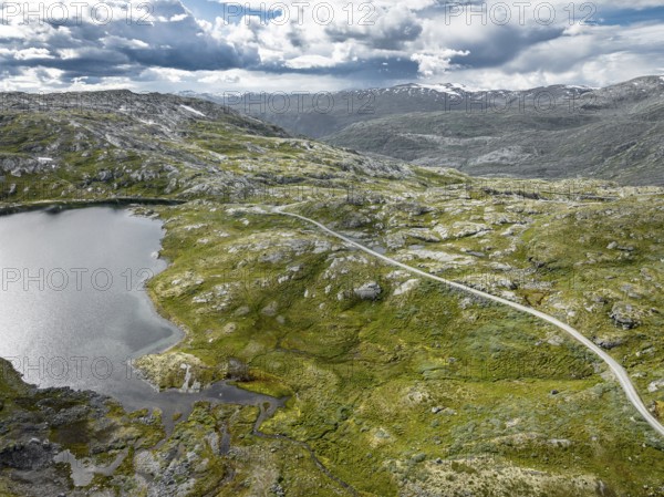 Typical landscape in norway with high snow covered mountains and deep lakes