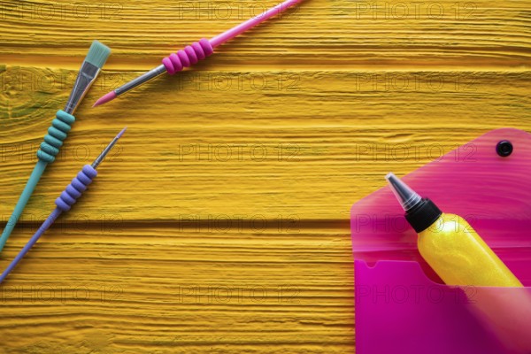 Back to school supplies arrangement vivid colorful neon color on yellow