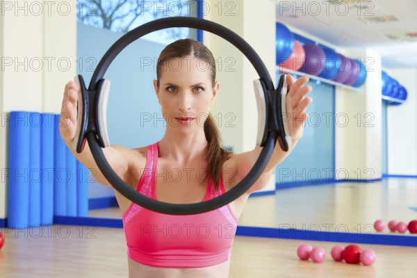 Pilates woman magic ring hands exercise workout at gym indoor