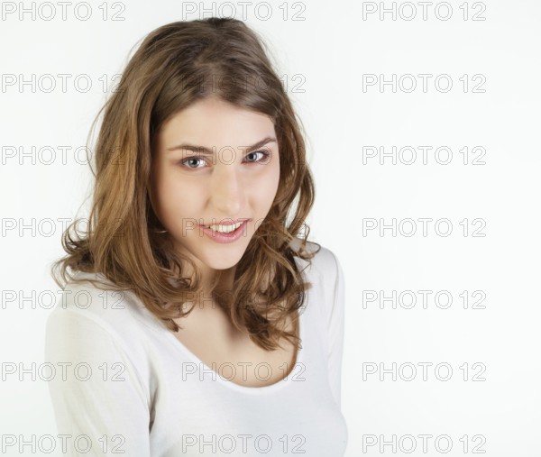 Portrait of pretty young woman against white background, Belgium, Europe