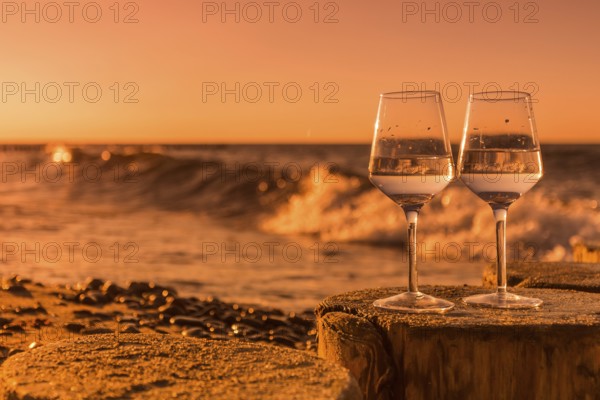 Wine on the baltic sea beach at sunset