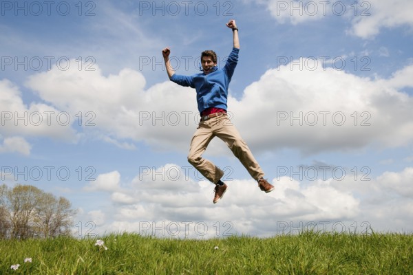 Happy jumping man outdoor in the fields