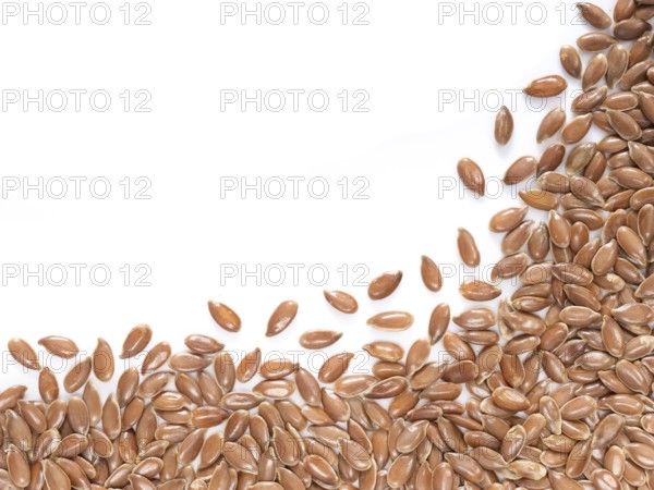 Brown flax seed with copy space. Isolated one edge. Top view or flat lay