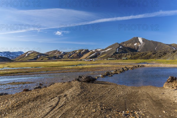 Camping site with cars and tents in a valley on July 09, 2013 in Landmannalaugar, Iceland, Europe