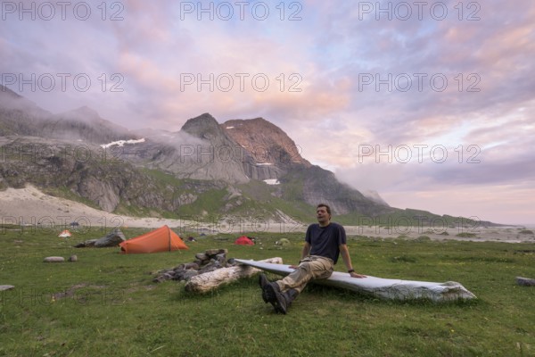 Man resting by the tent, Buneset, Moskenesöya, Lofoten, Nordland, Norway, July 2015, Europe