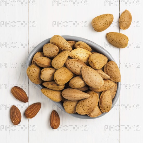 Almond on white wooden background