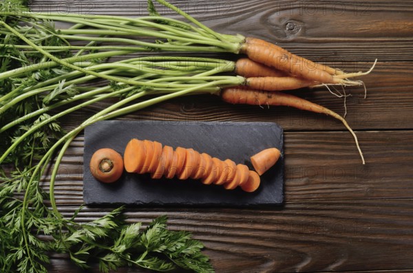 Top view at fresh organic Carrots on kitchen wooden table