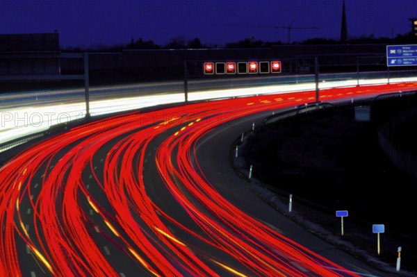 Many cars drive on a motorway at night and create light trails. Austria