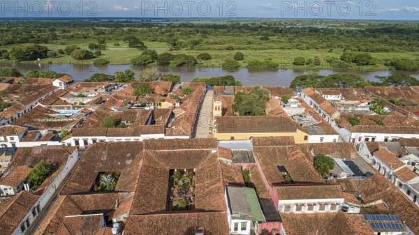 Aerial view of the historic town Santa Cruz de Mompox in sunlight with river and green sourrounding, World Heritage