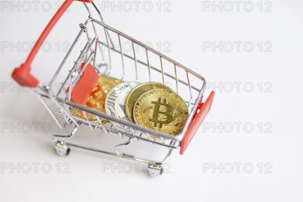 Photo of Shopping trolley cart with Coins bitcoin, buying goods for crypto currency