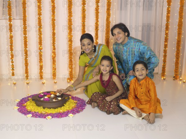 Woman lighting oil lamp with her family MR#779P, MR#779Q, MR#779R, MR#779S