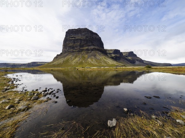 Rock massif Lomagnupur or Lómagnúpur, reflection in a pond, South Iceland, Iceland, Europe