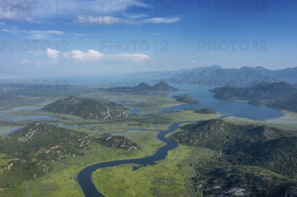 Aerial view of Rijeka Crnojevica, beautiful river between mountains flowing into Skadar Lake, Montenegro, Europe