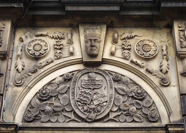 Sowerby bridge, west yorkshire, united kingdom, 16 july 2019: carved heraldic logo over the former lancashire and yorkshire bank in sowerby bridge