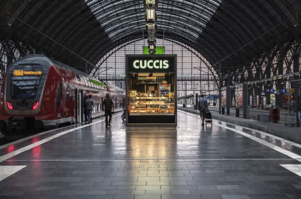 Germany, 23.07.2018: Travellers walk to a waiting local train on the platform at the main station, Europe