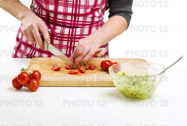 Young Woman Cooking in the kitchen. Healthy Food - Vegetable Salad