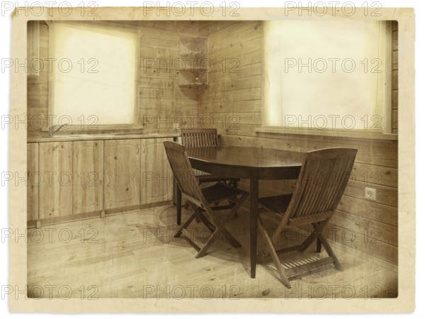 Old (stylized) photo of kitchen interior in a wooden blockhouse