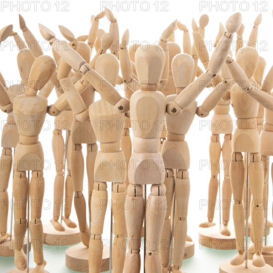 Many wooden mannequins isolated over white