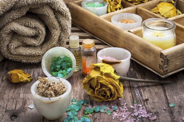Sea aromatic salt for Spa treatments on the background of yellow rose buds
