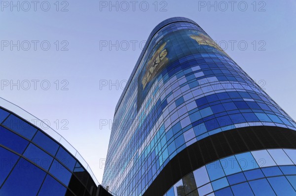 A modern skyscraper with a blue reflective glass facade and advertising, illuminated in daylight, Las Vegas Strip, Las Vegas, Nevada, USA, North America