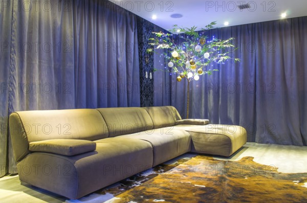 Beautiful living room with modern Christmas decoration, bamboo decorated with ornaments and Christmas lights