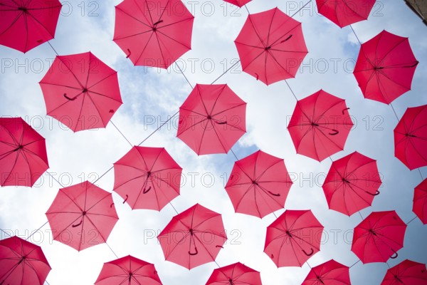 Sky filled with red umbrellas