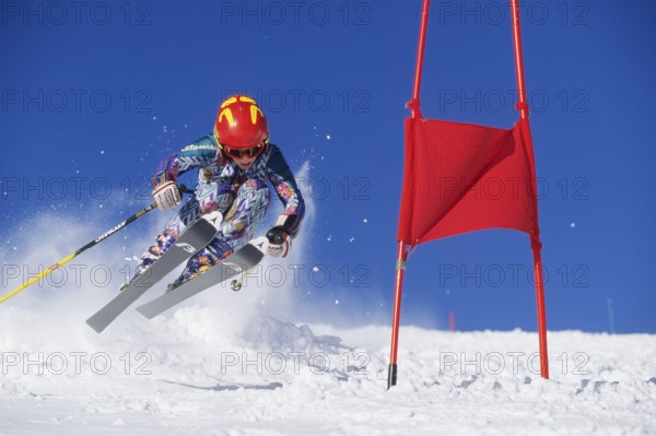 Skiers in action, descent on a slope, deep snow