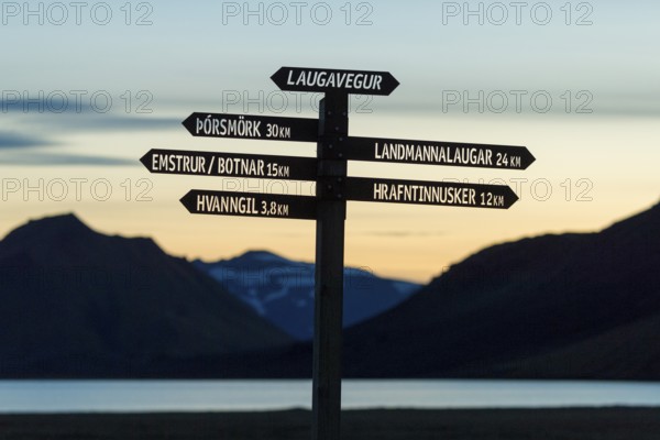 Signpost for hikers stands out against the evening sky, Laugavegur, Iceland's most famous hiking trail, Highlands, Iceland, Europe