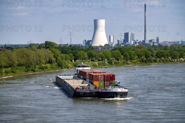 Cargo ship Mellizo, container freighter, only partly loaded, on the Rhine near Duisburg-Baerl, in the background the STEAG power plant Walsum North Rhine-Westphalia, Germany, Europe