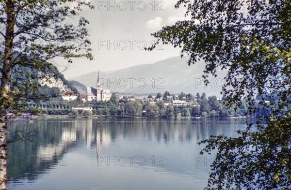 View over water of to church of Saint Martin and town, Lake Bled, Bled, Slovenia, former Yugoslavia, Europe 1959, Europe