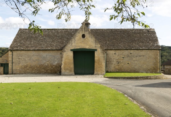 Historic nineteenth century farmyard stone barn building, Yanworth, Gloucestershire, England, UK